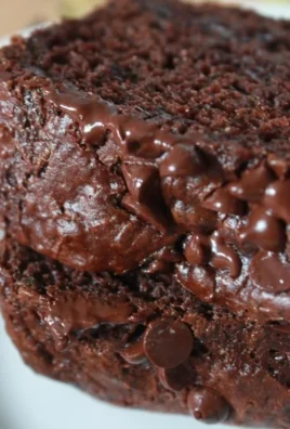 Delicious chocolate zucchini loaf fresh from the oven, topped with chocolate chips