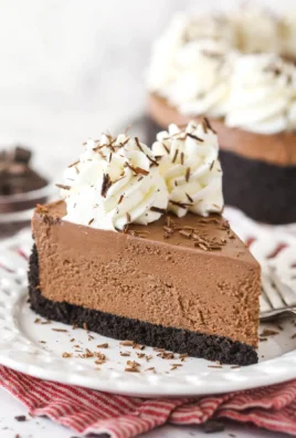 No bake chocolate cheesecake topped with chocolate shavings on a white plate