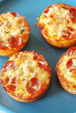 Homemade pizza muffins for toddlers and kids, topped with cheese and pepperoni.