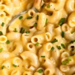 Bowl of creamy gluten-free mac and cheese topped with breadcrumbs