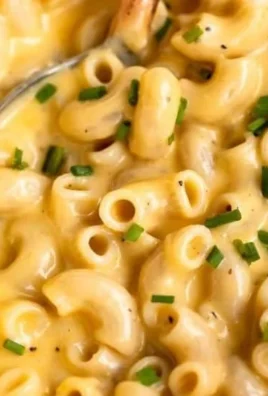 Bowl of creamy gluten-free mac and cheese topped with breadcrumbs