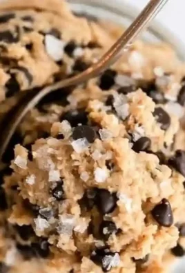 Bowl of healthy edible protein cookie dough with chocolate chips and nuts