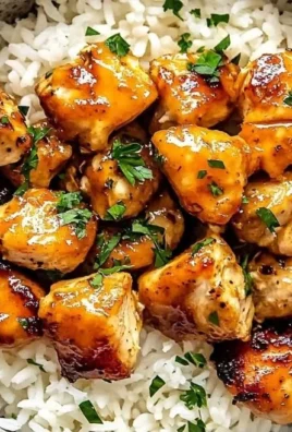 Delicious Hot Honey Chicken Bowls topped with fresh vegetables and honey drizzle.