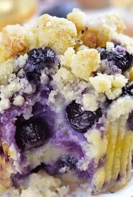 Homemade lemon blueberry muffins with a golden brown top and fresh blueberries