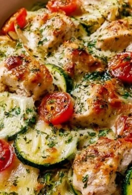 Mediterranean Chicken Zucchini Bake served in a white dish with fresh herbs