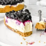 Delicious no bake blueberry cheesecake topped with fresh blueberries.