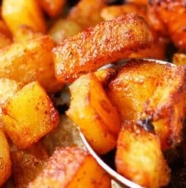 Deliciously seasoned roasted potatoes served on a plate