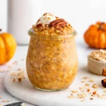 Delicious bowl of Pumpkin Pie Overnight Oats with spices and pumpkin puree