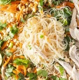 Bowl of Rice Noodle Salad with Chicken, colorful vegetables, and dressing