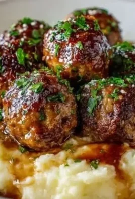 Salisbury steak meatballs with garlic herb mashed potatoes on a plate