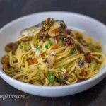Delicious bowl of Spanish sardines pasta with sun dried tomatoes and olives
