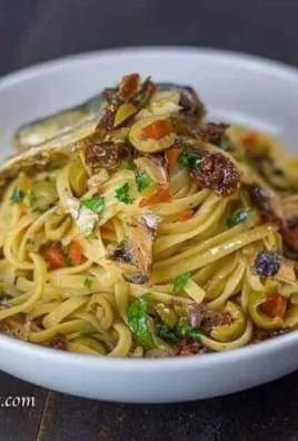 Delicious bowl of Spanish sardines pasta with sun dried tomatoes and olives