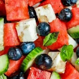 Fresh Watermelon Cucumber Feta Salad served in a bowl with mint leaves.