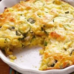 Homemade Zucchini Pie served on a plate with fresh herbs and greens