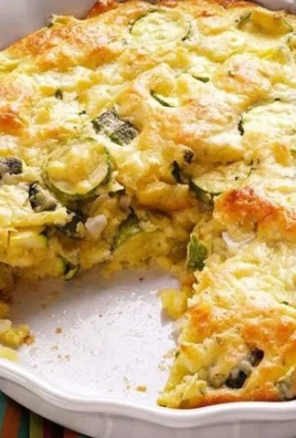 Homemade Zucchini Pie served on a plate with fresh herbs and greens